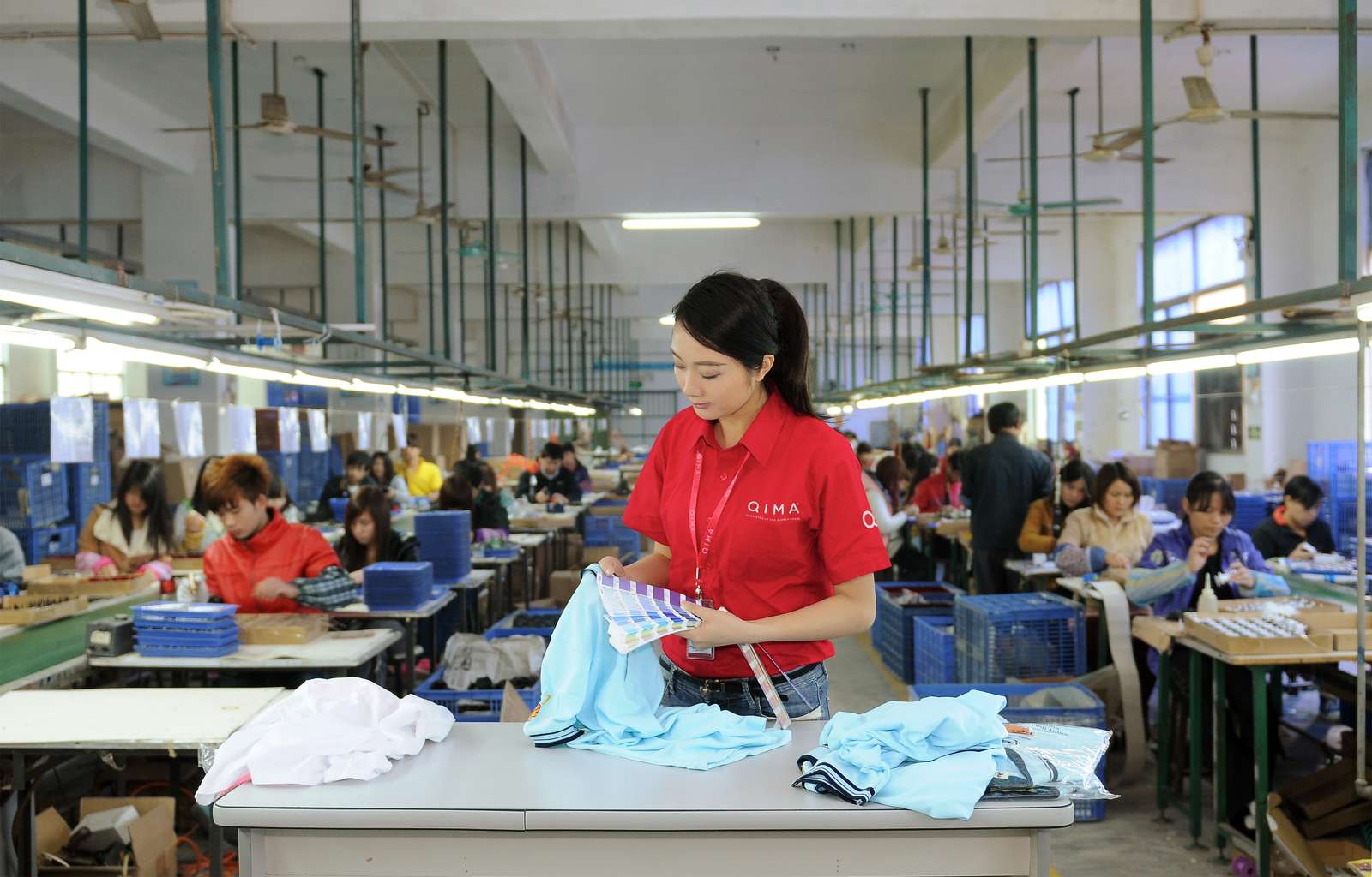 Garment quality control inspector checking color of shirt | QIMA