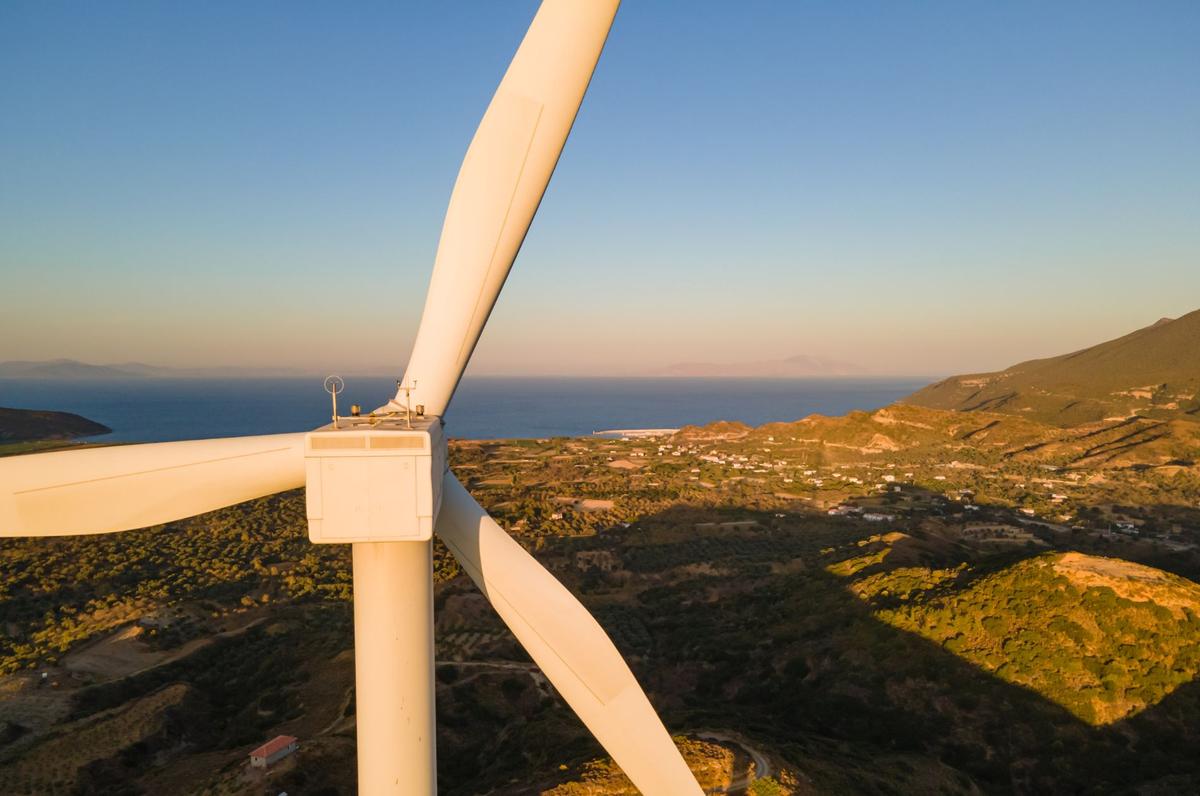 a windmill with a body of water in the background